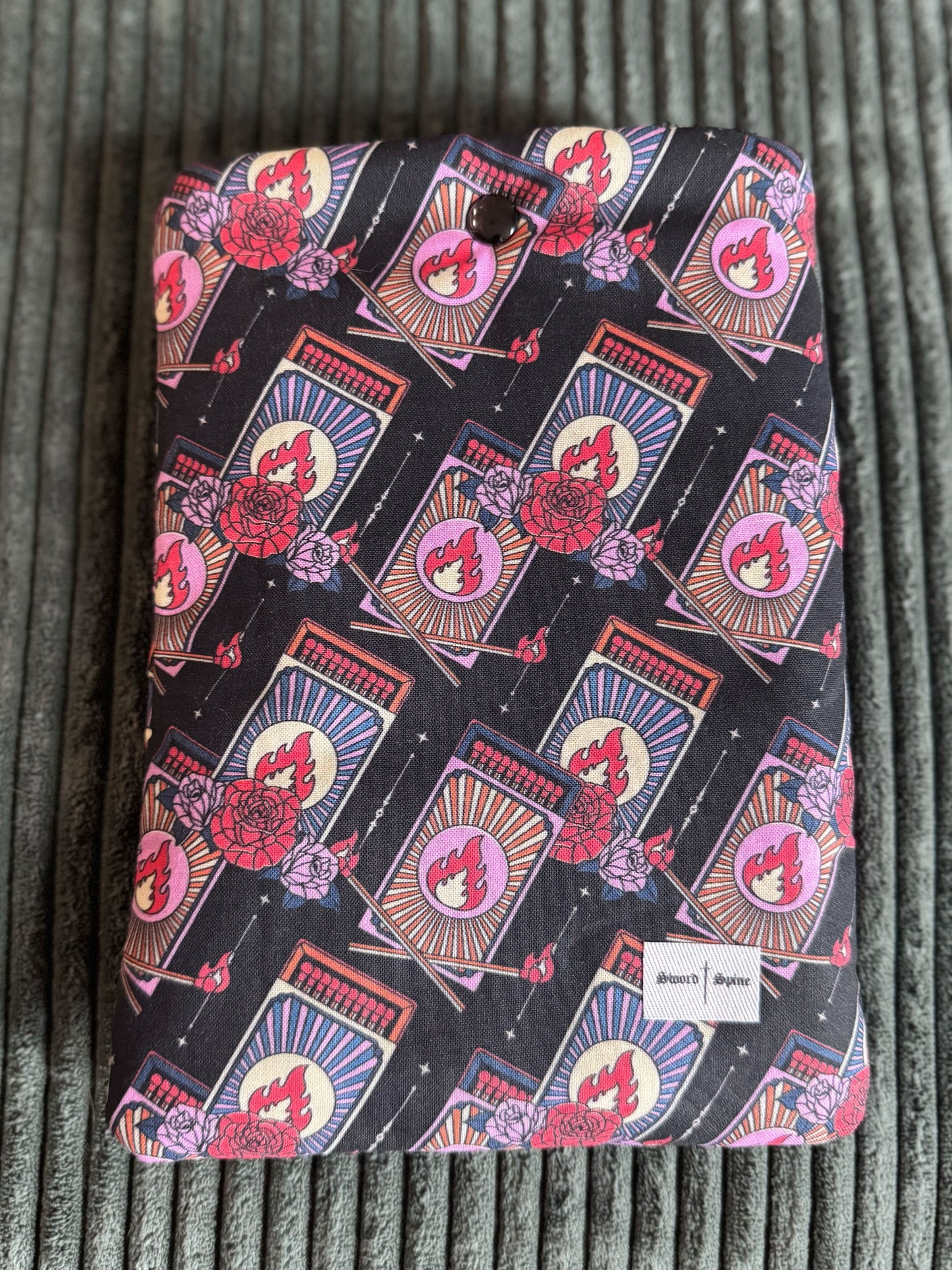 A handmade kindle e-reader sleeve shows a repeated pattern of matchboxes.
