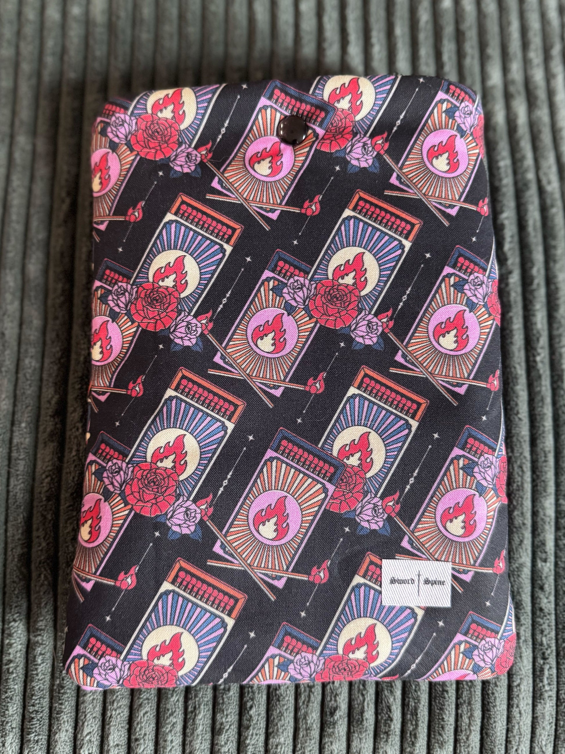 A handmade kindle e-reader sleeve shows a repeated pattern of matchboxes.