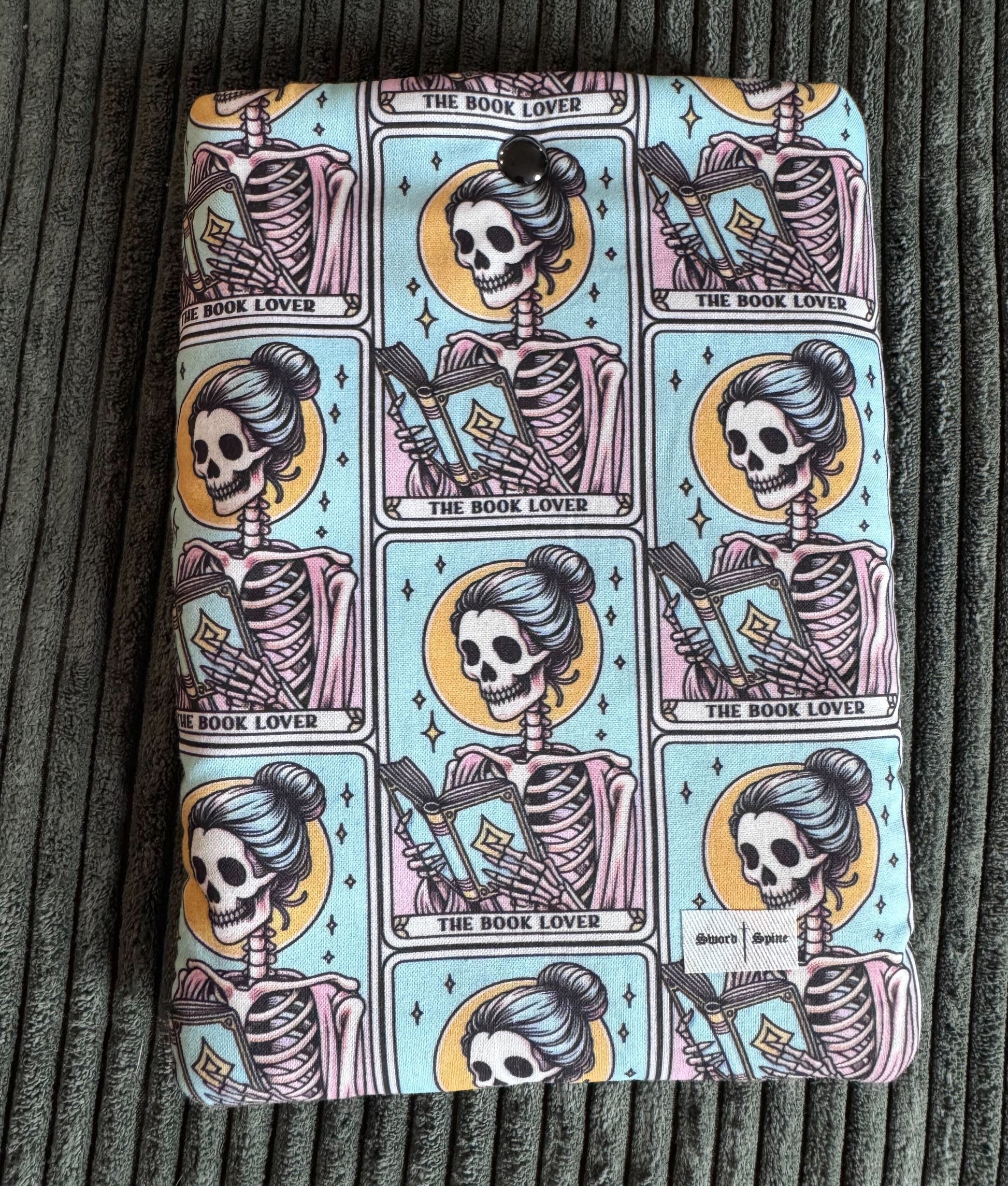 A padded e-reader sleeve with a pattern of tarot cards for book lovers.