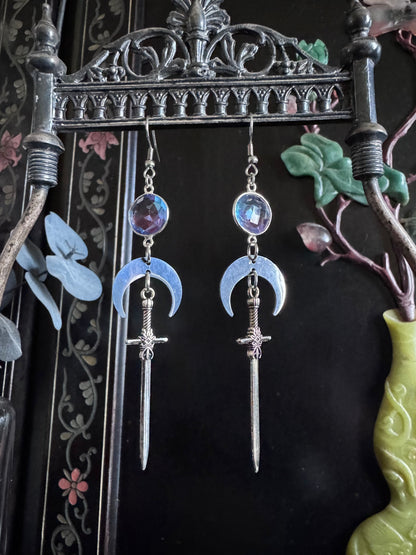 Purple and blue ombre gemstone earrings feature silver swords and crescent moons.