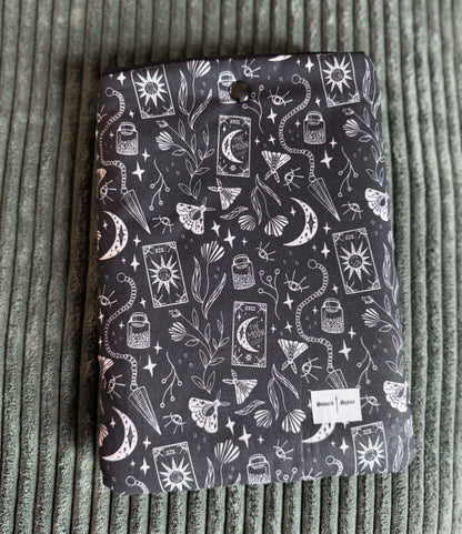 A black and white kindle e-reader sleeve with a pattern of tarot cards and pendulums.